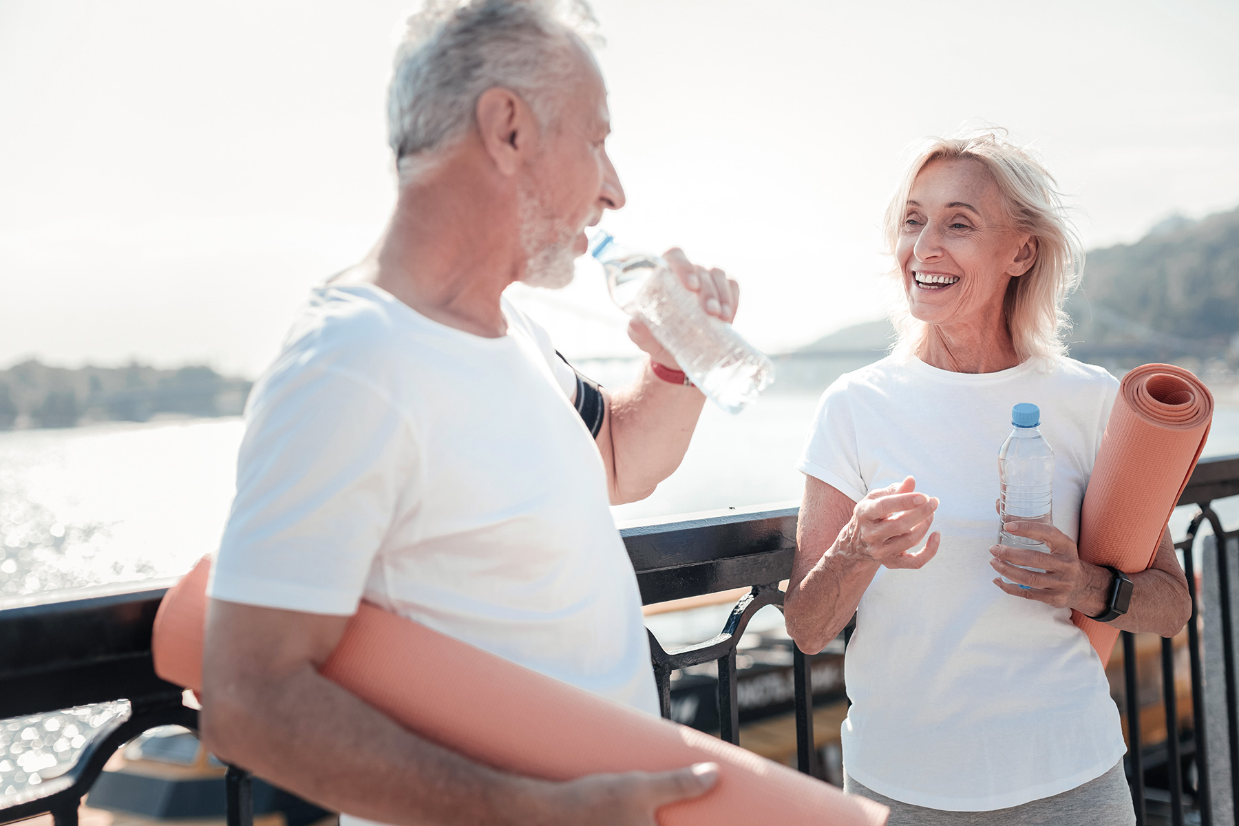 Man and Woman with a Yoga Mat and Water Bottles